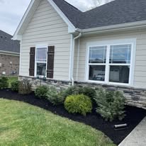 Renewed beds around brick exterior