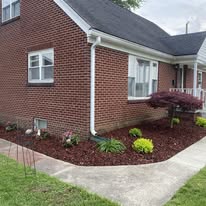 Mowing beside a brick home